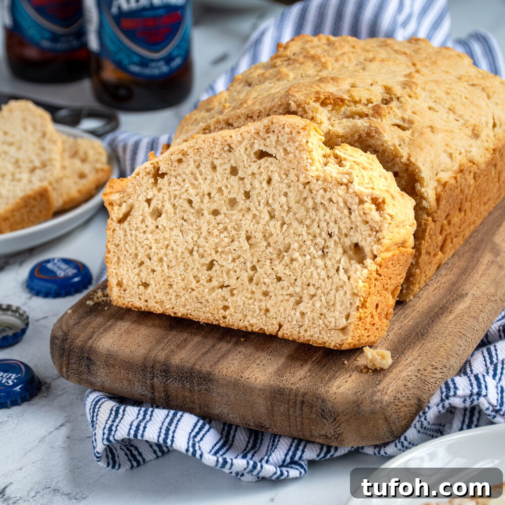 Slow-Cooker Beef Stew with Tender Chunks and Veggies 8 A slice of beer bread on a cutting board propped up against a loaf of easy beer bread.