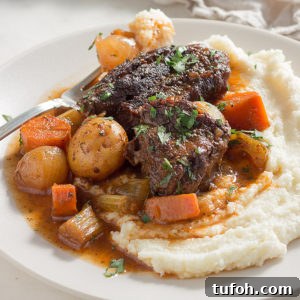 Low carb pot roast with vegetables in gravy served on cauliflower mash. keto, LCHF