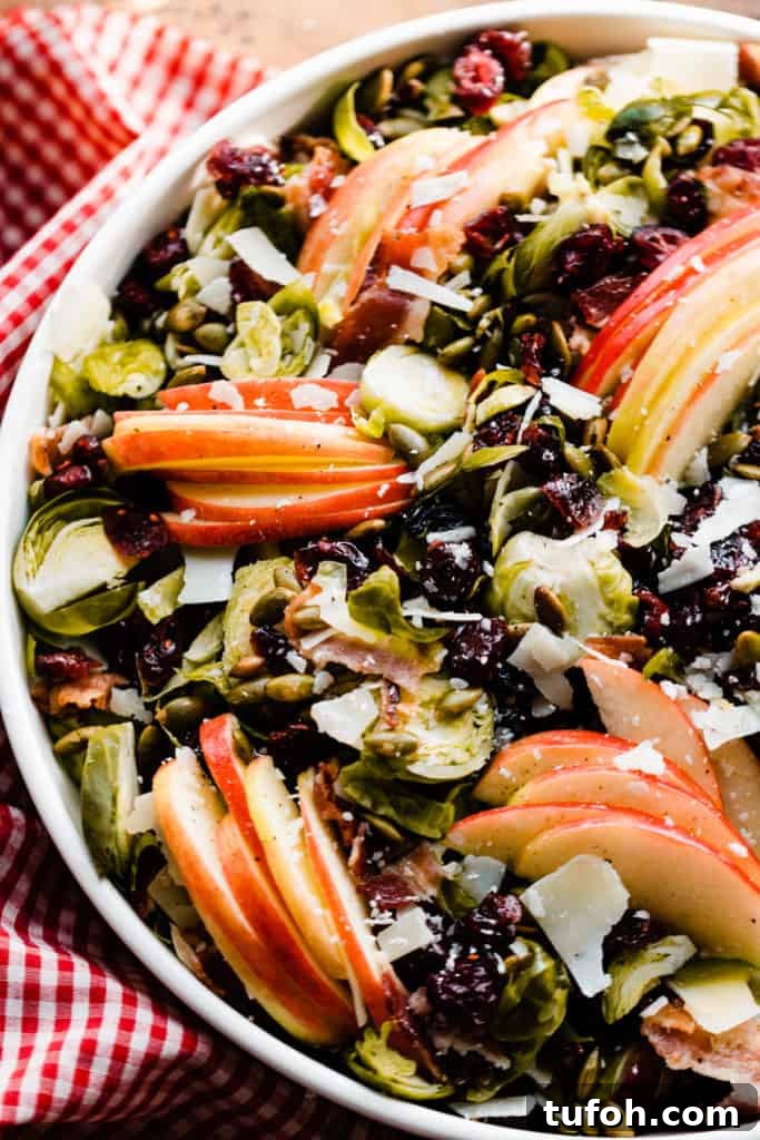 A close-up on the bowl of salad with the red checked linen peeking out