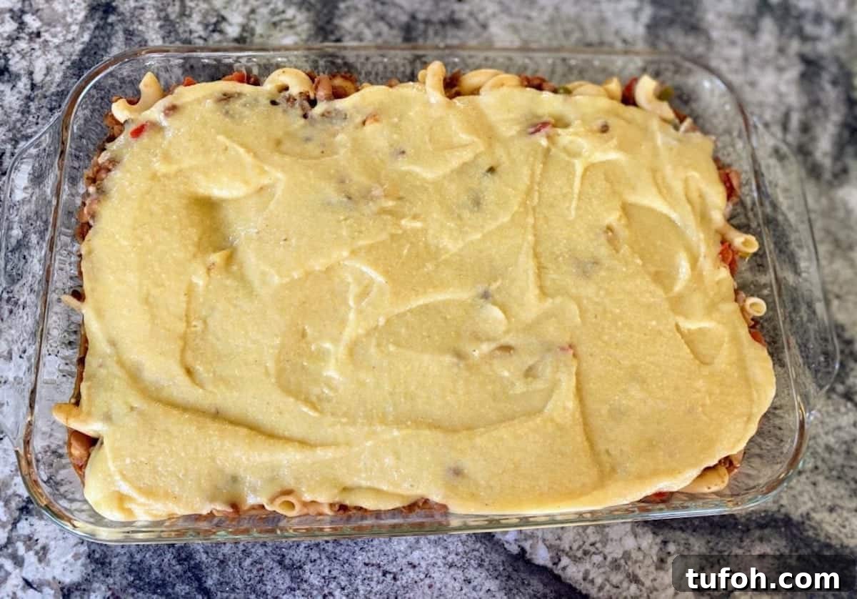 9 x ! 3-inch pan of vegan casserole with vegan cornbread spread in a thin layer over the top. 