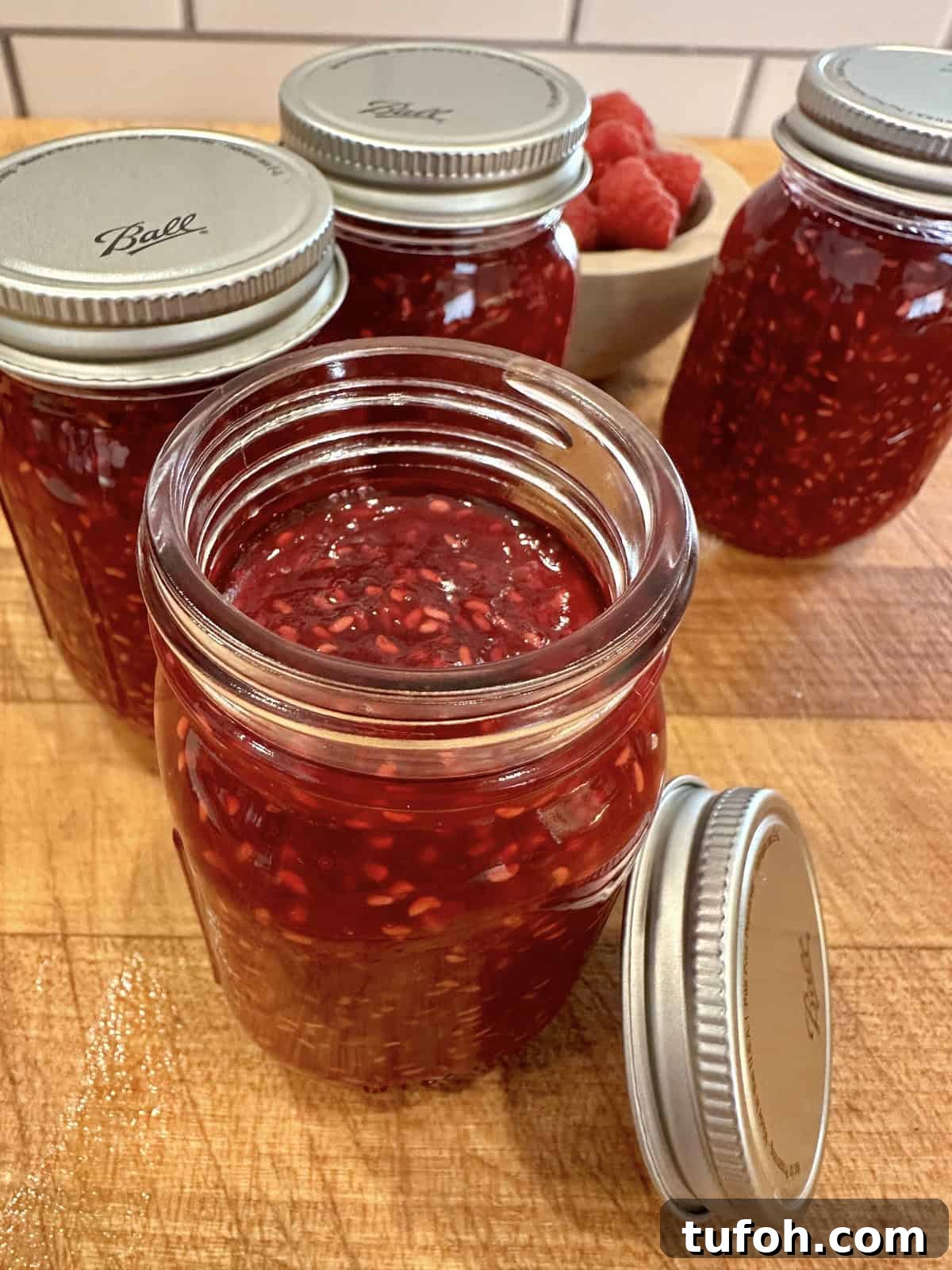 No-Cook Raspberry Jam Without Pectin or Canning 11 Easy small batch raspberry jam in jars with lids.