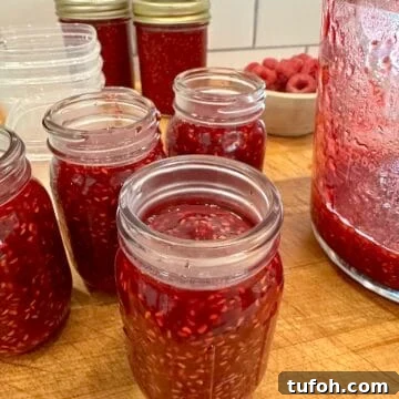 No-Cook Raspberry Jam Without Pectin or Canning 12 Easy small batch raspberry jam in jars on a cutting board.