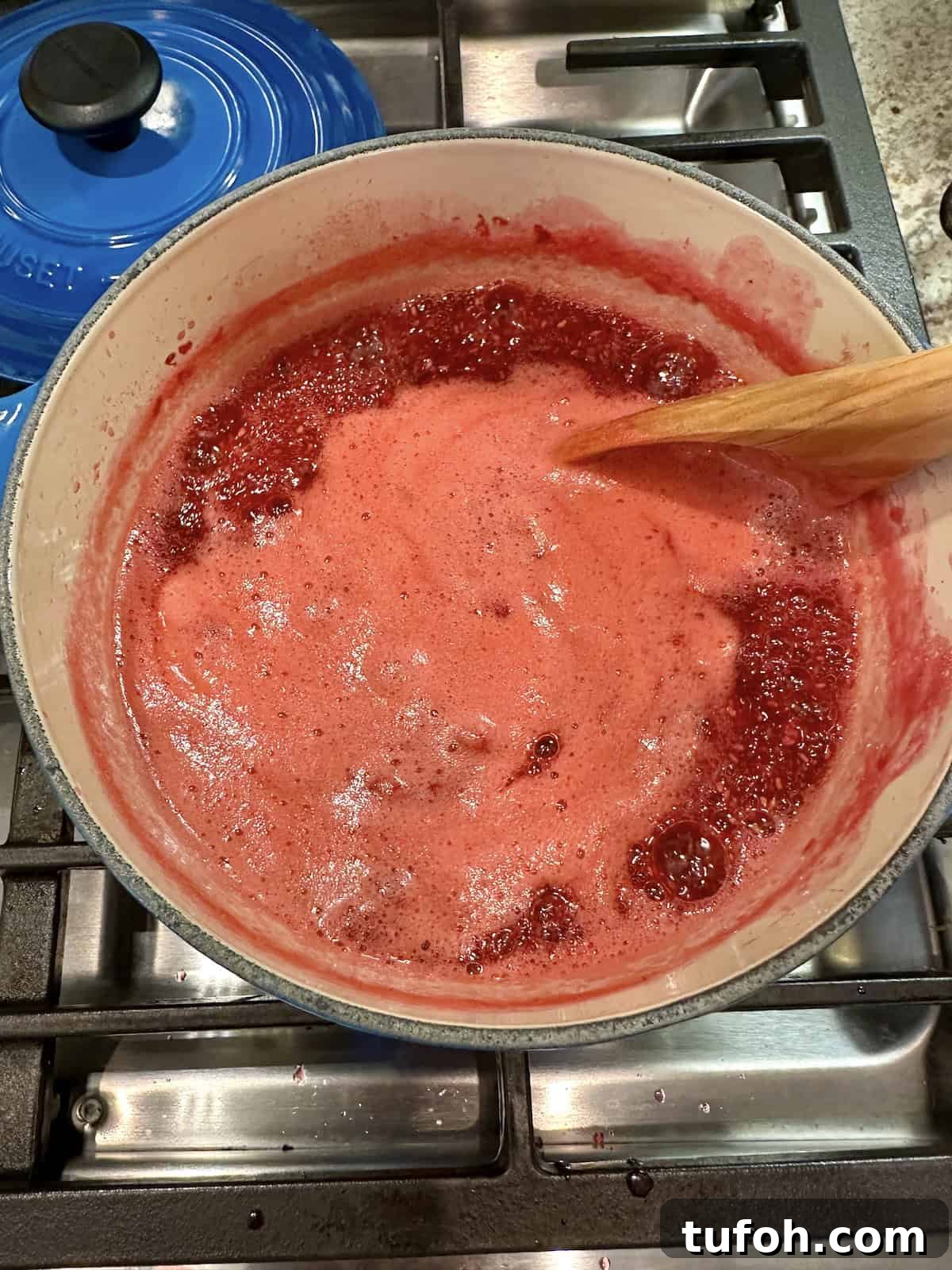 No-Cook Raspberry Jam Without Pectin or Canning 6 Raspberry jam simmering in a pan on the stove.