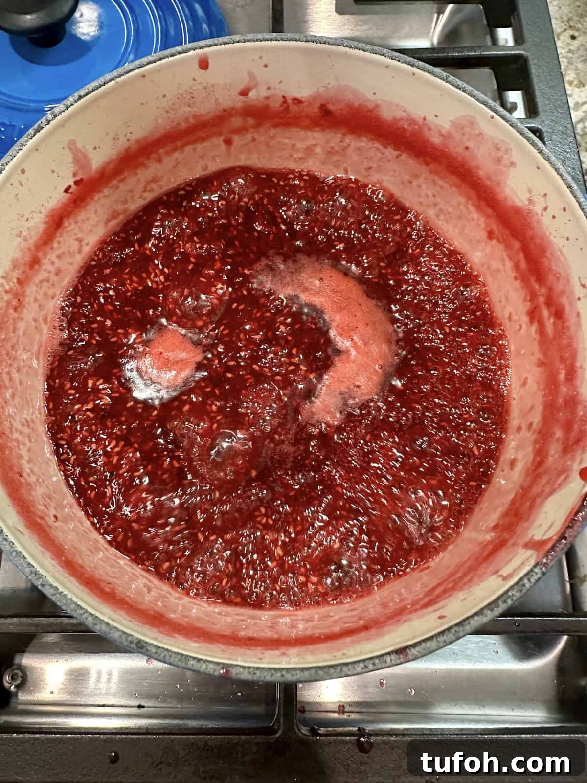 No-Cook Raspberry Jam Without Pectin or Canning 7 Raspberry jam boiling on the stove, no pectin and no canning.