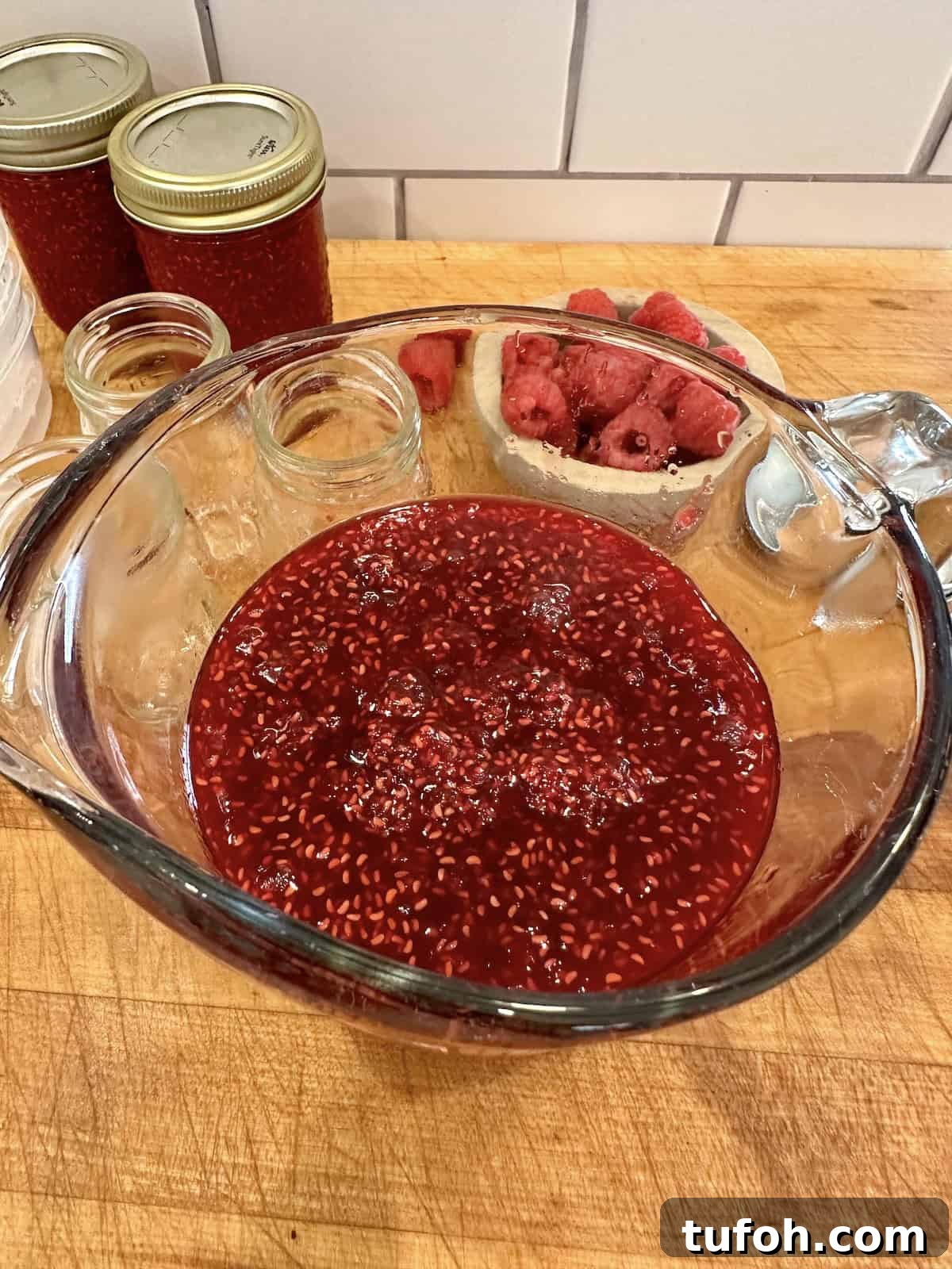 No-Cook Raspberry Jam Without Pectin or Canning 8 Small batch raspberry jam in a glass measuring cup.