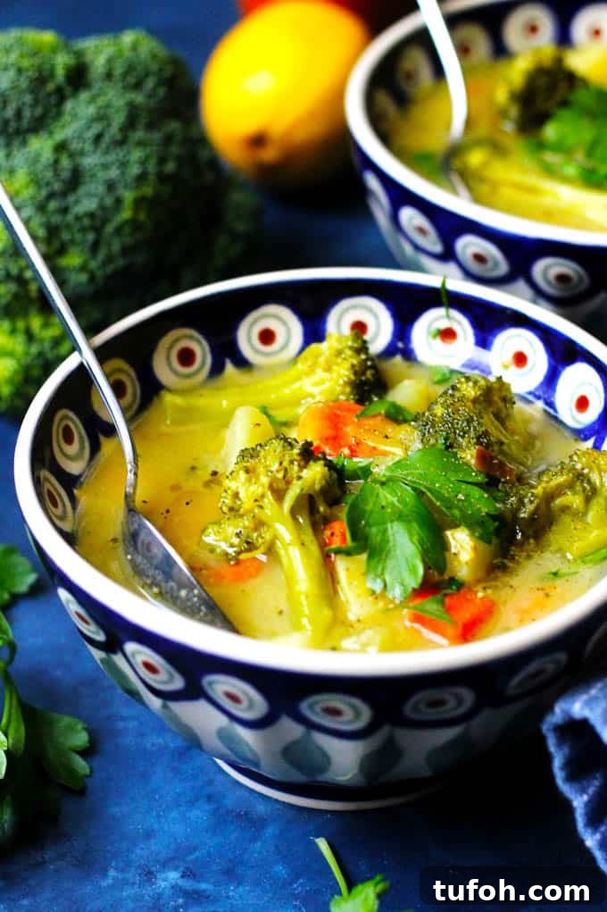 Creamy European Broccoli, Leek & Potato Soup Recipe 15 A close up picture of Broccoli Leek Potato Soup in a blue and white bowl