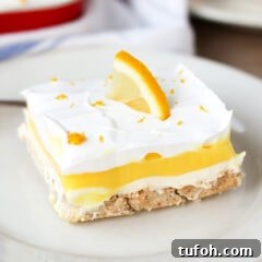 Decadent Lemon Lush Dessert Recipe: Creamy Layered Lemon Bars 2 Close up photo of Lemon Lush on a plate