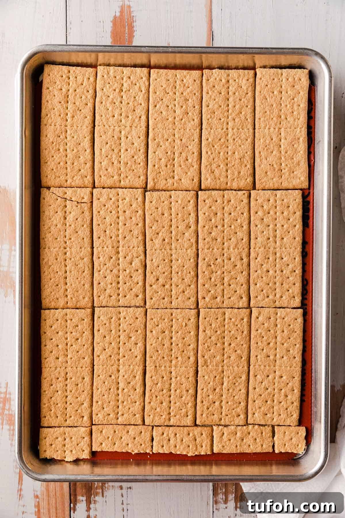 Graham Cracker Praline Recipe — Crunchy Caramel Candy Tutorial 4 Graham crackers on a large sheet pan.
