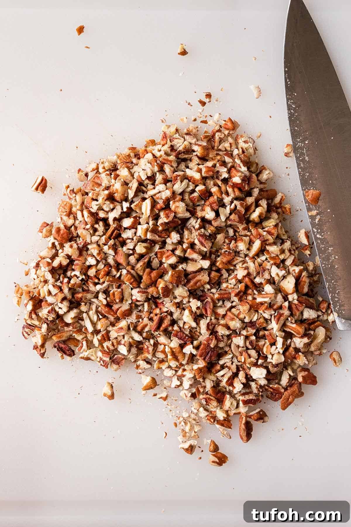 Graham Cracker Praline Recipe — Crunchy Caramel Candy Tutorial 8 Chopped pecans on a cutting board.