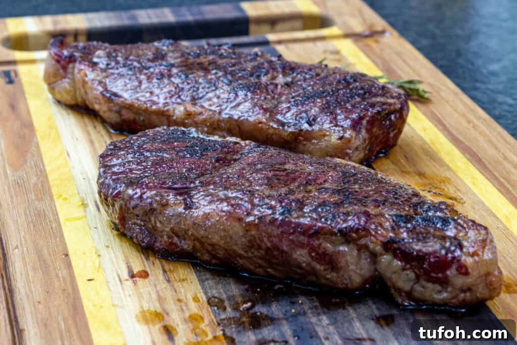 Smoked New York Strip Steak: Step-by-Step Smoking Guide 5 smoked new york strips on a cutting board