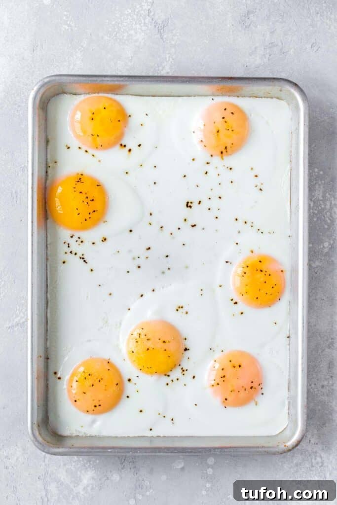 A sheet pan with cooked sunny side up eggs.