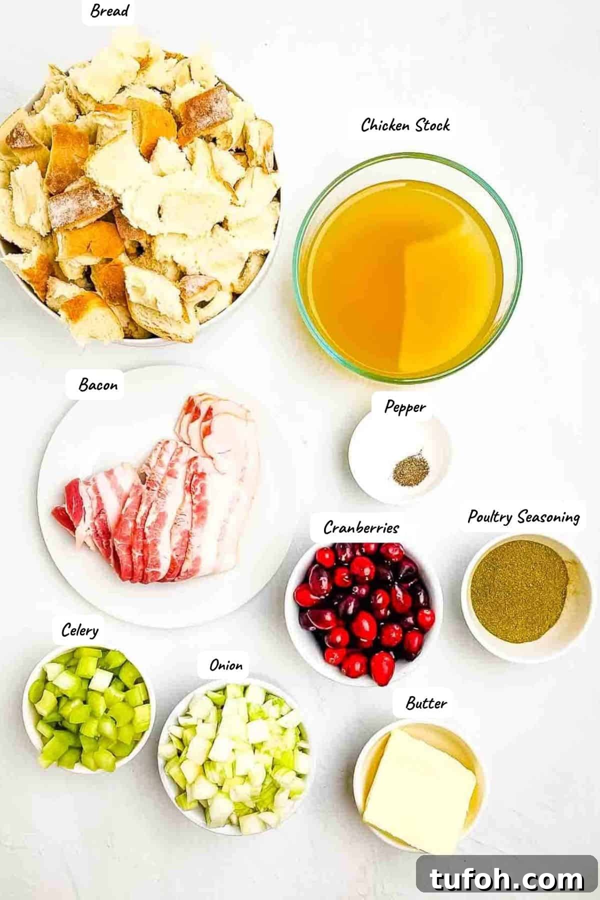 Savory Bacon and Cranberry Stuffing Recipe for Holidays 3 The ingredients for the homemade stuffing measured out and placed on a white table.