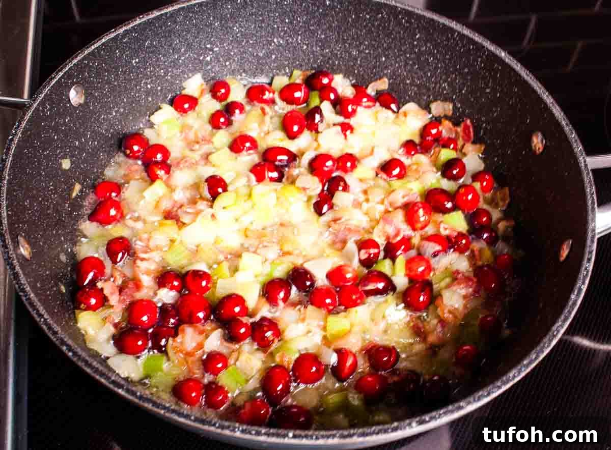Savory Bacon and Cranberry Stuffing Recipe for Holidays 5 The cranberries and butter added to the large skillet.