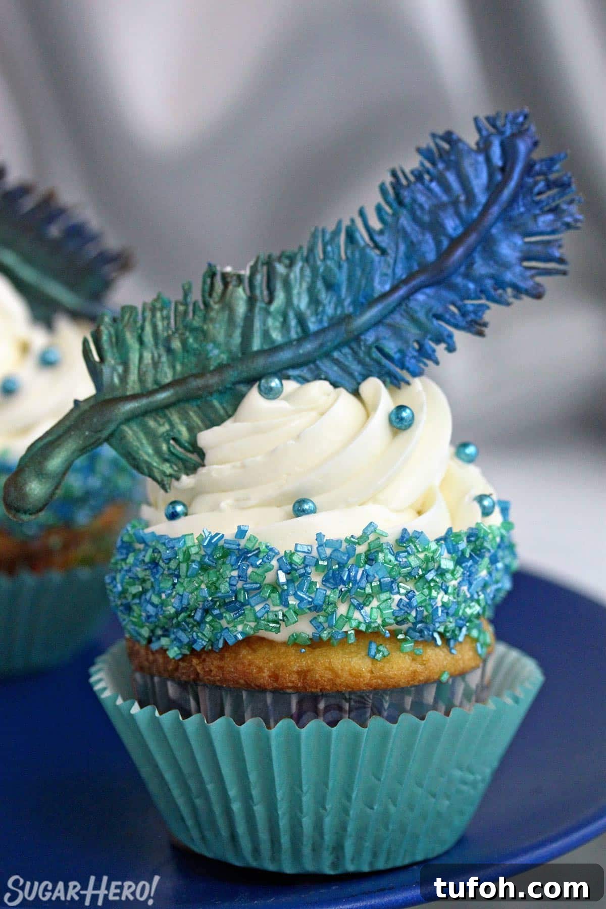 Decadent Chocolate Feather Cookies Recipe 4 Cupcake on a blue plate with a blue-green chocolate feather on top.