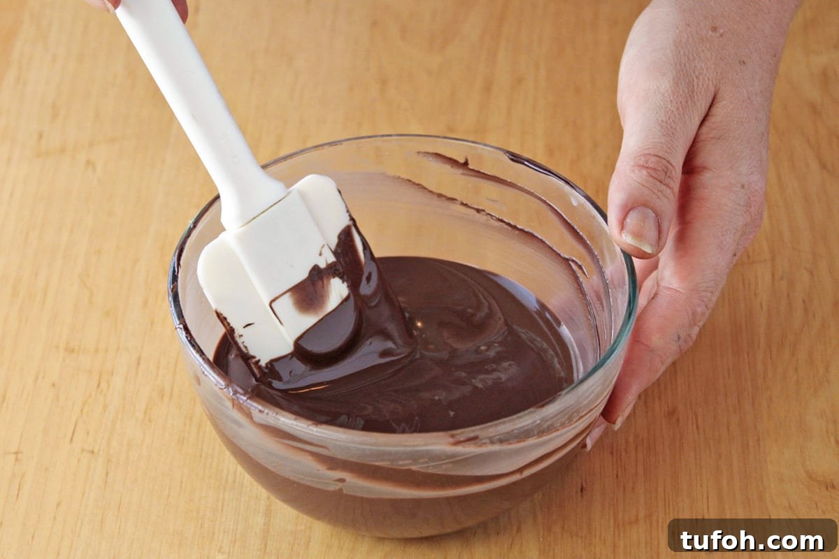 Decadent Chocolate Feather Cookies Recipe 6 Hands stirring melted candy coating.