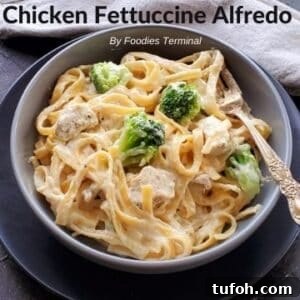 Creamy Instant Pot Chicken Fettuccine Alfredo with Broccoli 10 chicken fettuccine alfredo with broccoli in a grey bowl with a fork