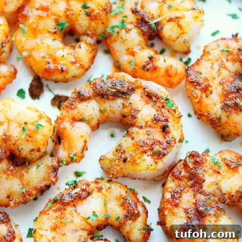Cooked shrimp on a white plate.