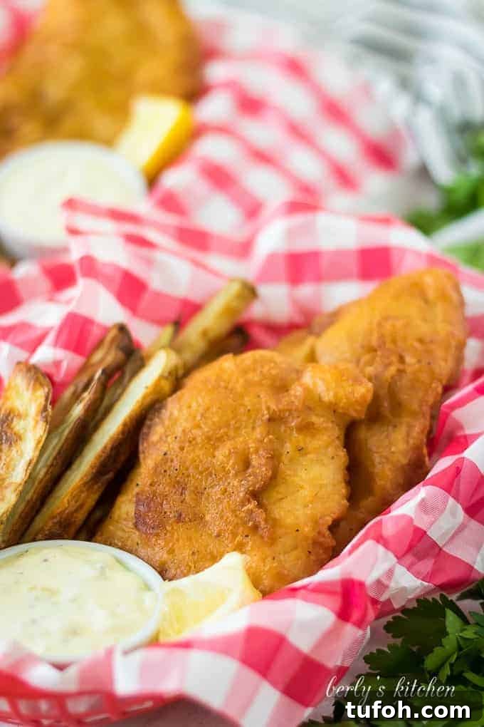 Crispy Beer-Battered Cod Recipe for Perfect Fish Fry 6 Fried fish, in a basket, served with fries and tartar sauce.