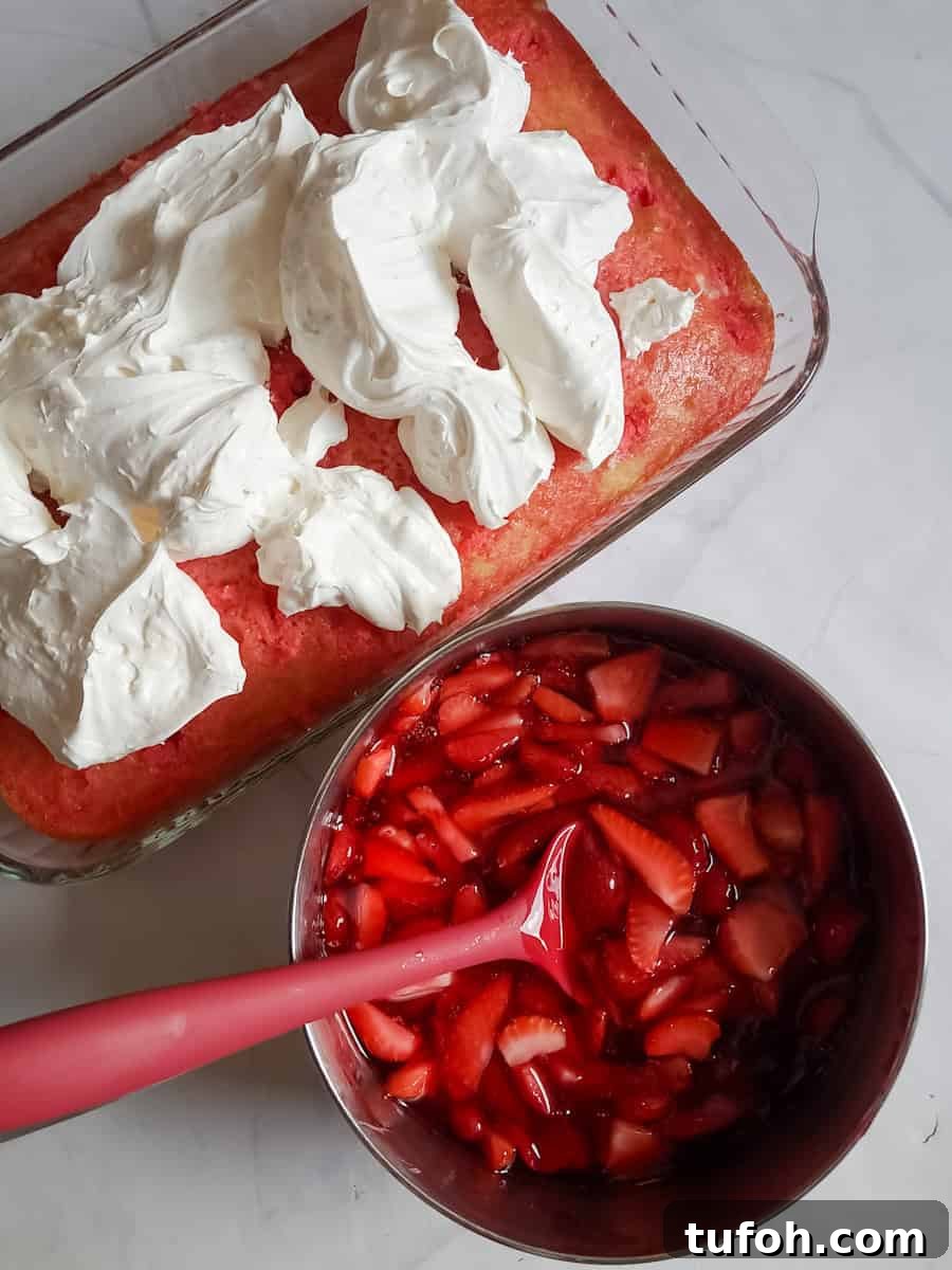 Amish Fruit Jello Cake Recipe: Classic Layered Dessert Guide 9 getting ready to assemble the layered jello cake: spreading the cream cheese filling over the cake, and strawberry filling goes on top.
