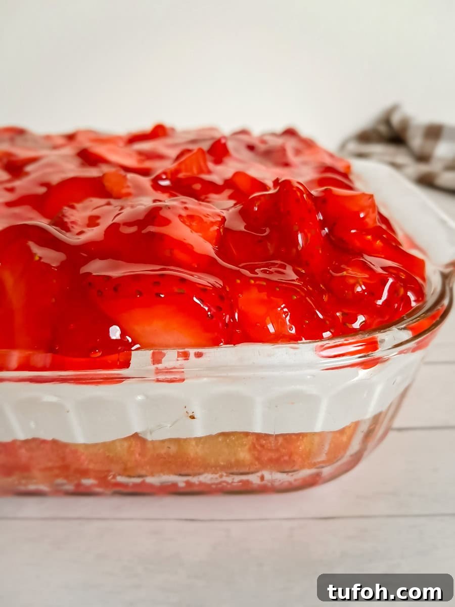 Amish Fruit Jello Cake Recipe: Classic Layered Dessert Guide 10 9x13" pan full of jello poke cake with fruit topping.