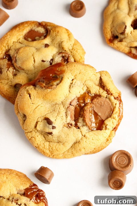 Rolo cookies on a white marble worktop with large and small Rolos scattered around them