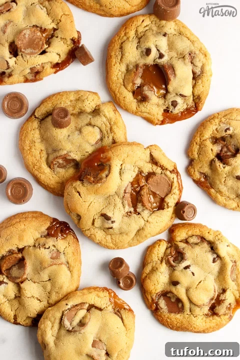 Rolo cookies on a white marble worktop with large and small Rolos scattered around them