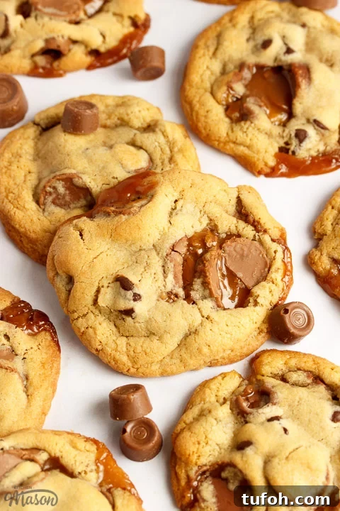Rolo cookies on a white marble worktop with large and small Rolos scattered around them
