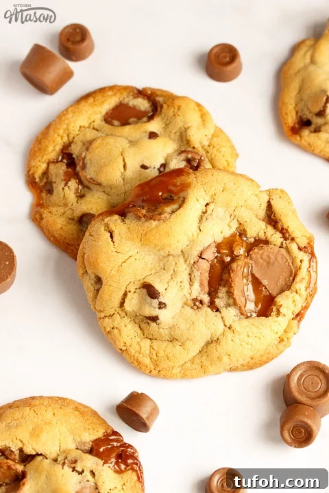 Rolo cookies on a white marble worktop with large and small Rolos scattered around them