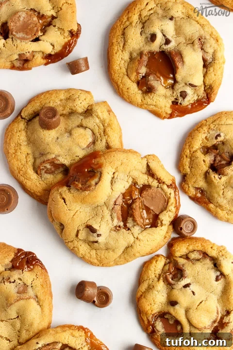 Rolo cookies on a white marble worktop with large and small Rolos scattered around them