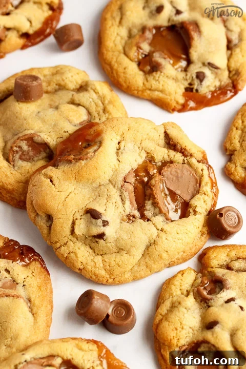 Rolo cookies on a white marble worktop with large and small Rolos scattered around them
