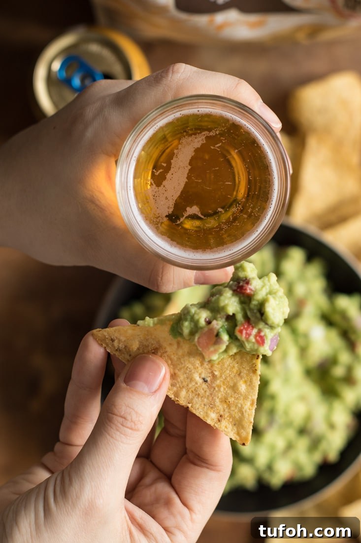 Creamy Vegan Guacamole Recipe for Parties and Snacks 4 Hands holding drink and tortilla with guacamole.