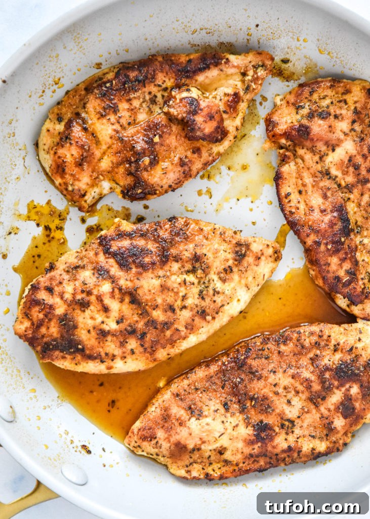 thin sliced stovetop chicken breasts just cooked in a pan.