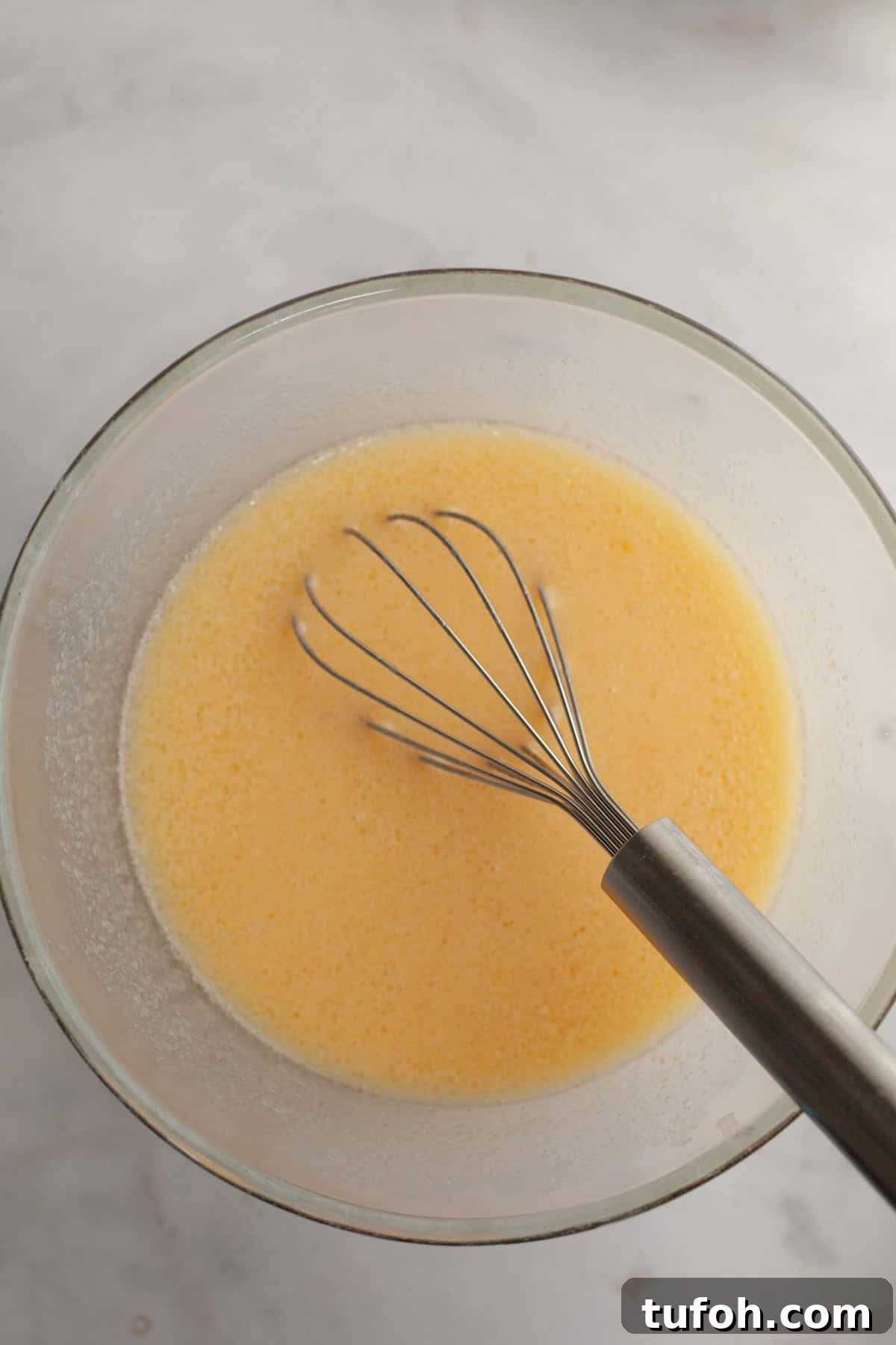 Cinnamon Mini Muffins Recipe: Quick, Soft & Flavorful 4 Melted butter, eggs, and sugar in a bowl with a whisk.