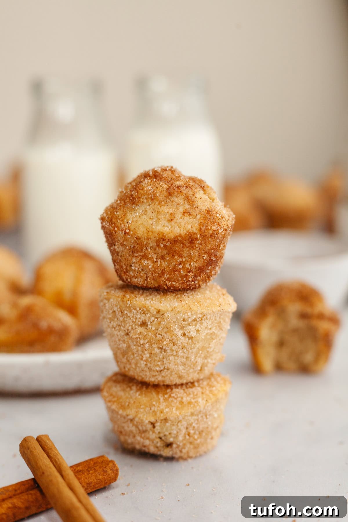 Cinnamon Mini Muffins Recipe: Quick, Soft & Flavorful 8 A stack of three cinnamon sugar mini muffins.