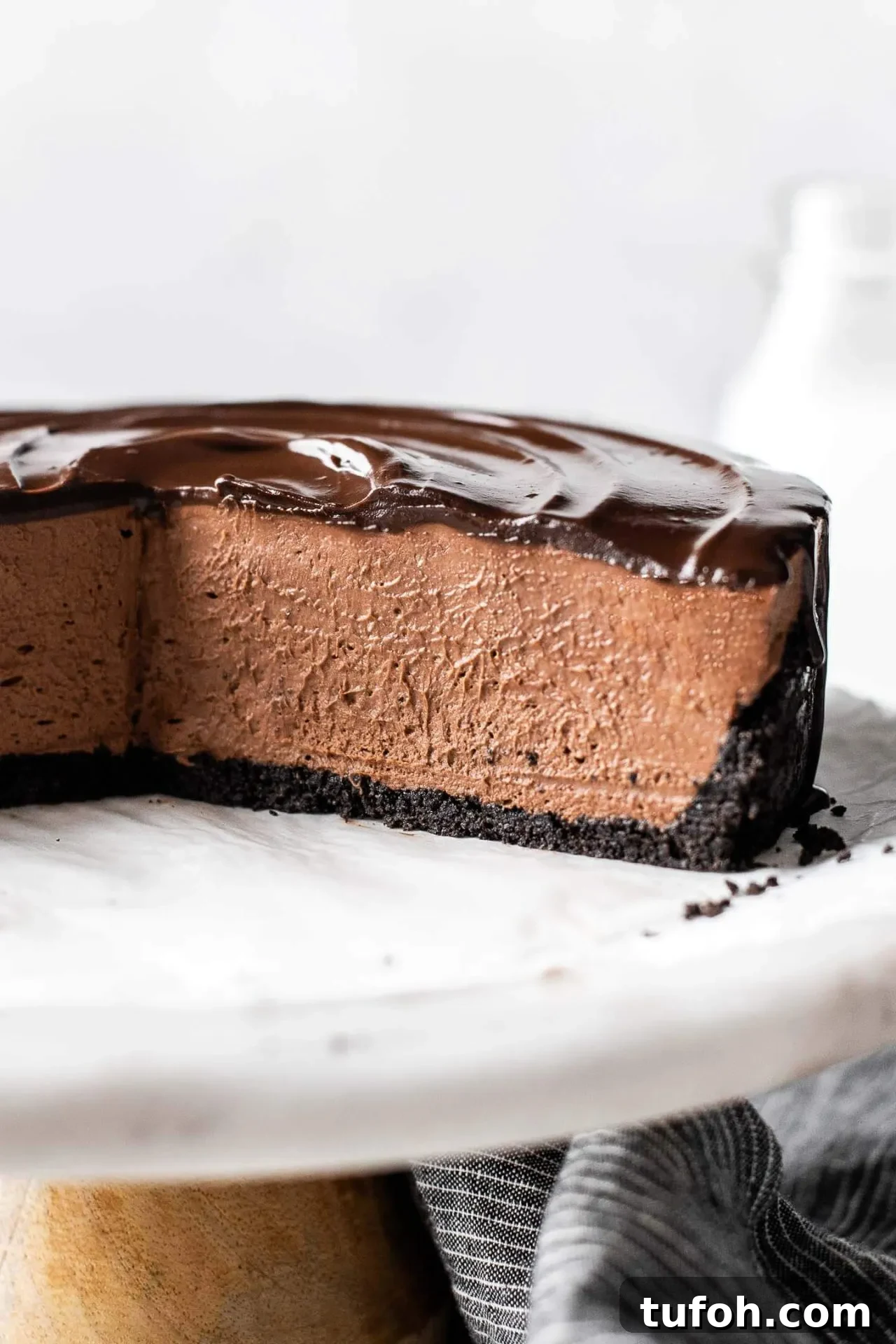 sliced no bake chocolate cheesecake on cake stand