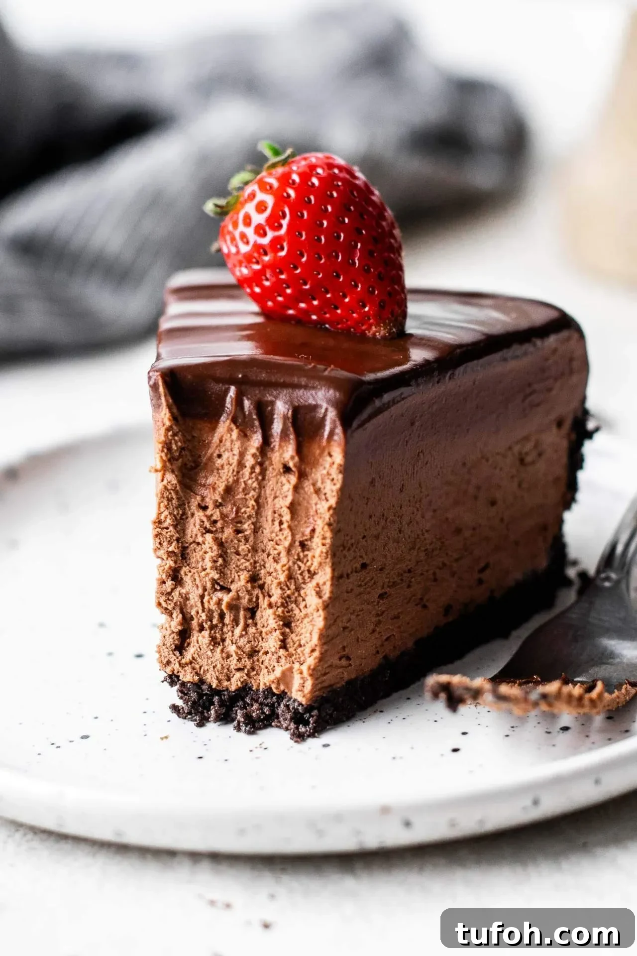 no bake chocolate cheesecake slice in plate with bite missing