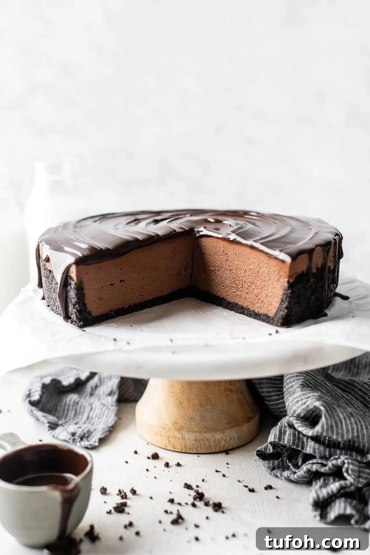 sliced no bake chocolate cheesecake on cake stand