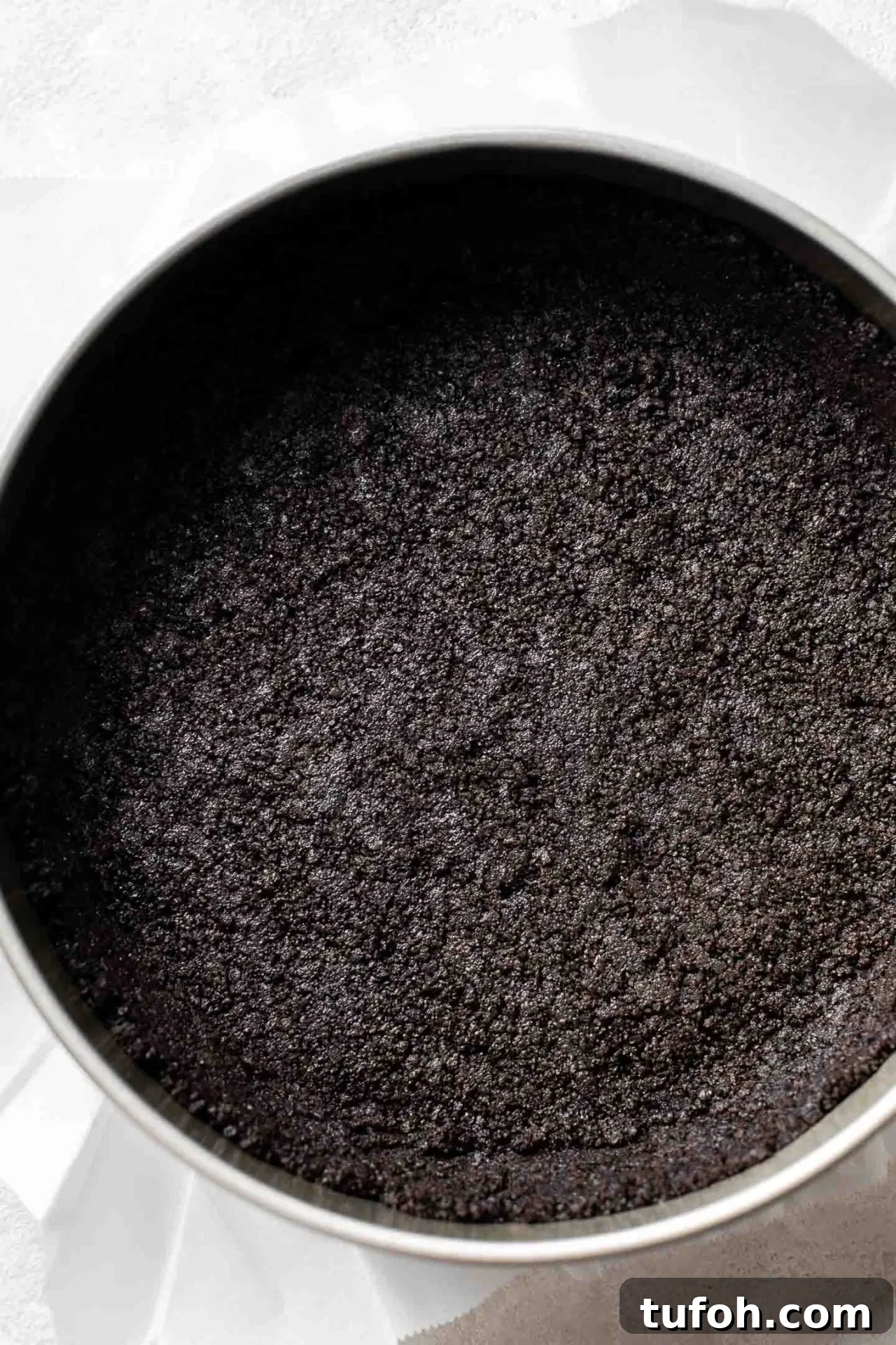 no bake chocolate cheesecake crust packed into springform pan