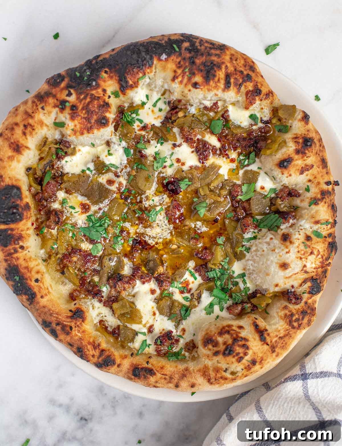 Green Chile and Chorizo Pizza Recipe with Melty Cheese 2 Green Chile Pizza on a wooden board.