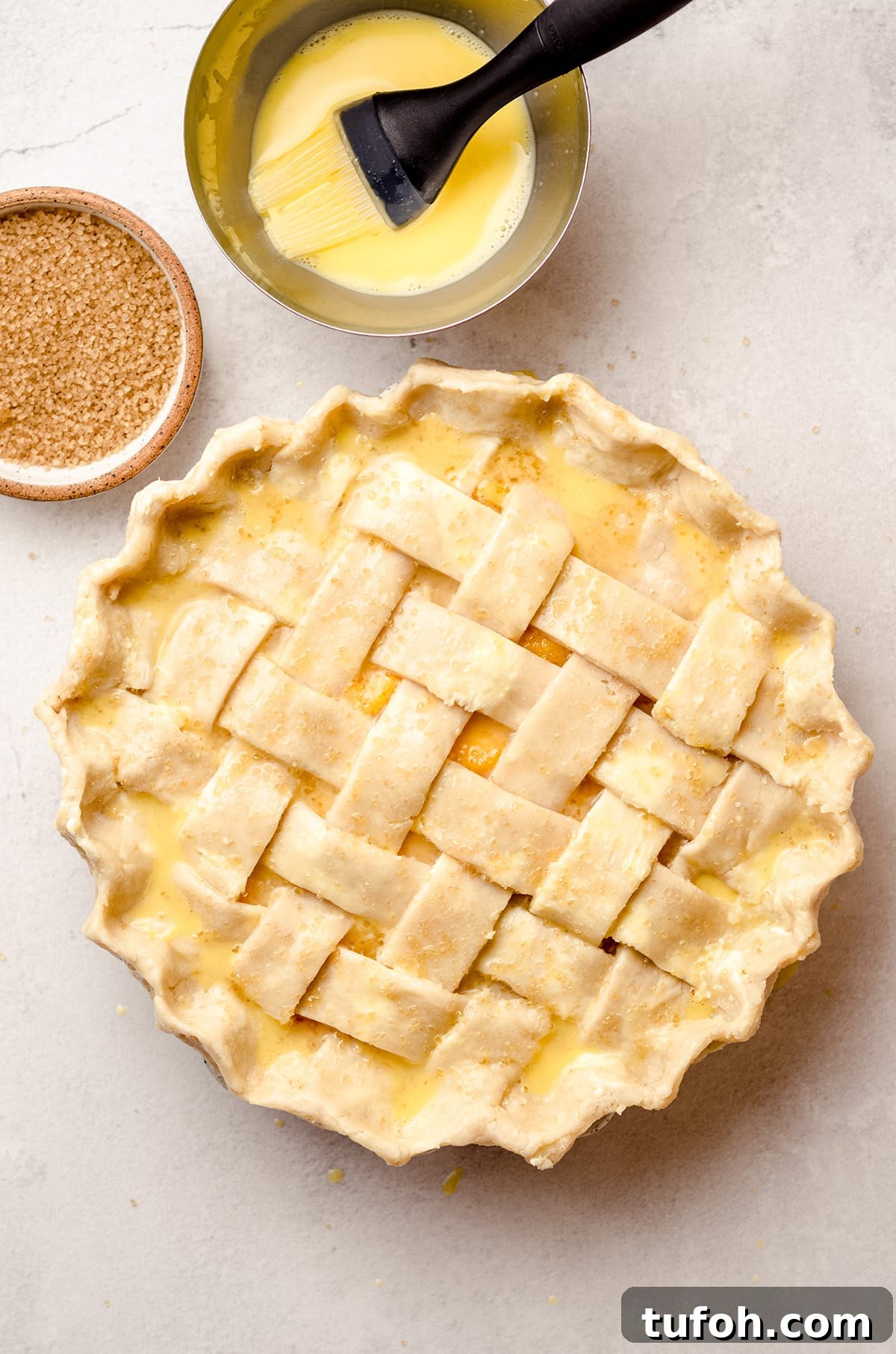 A lattice crust pie, brushed with an egg wash.