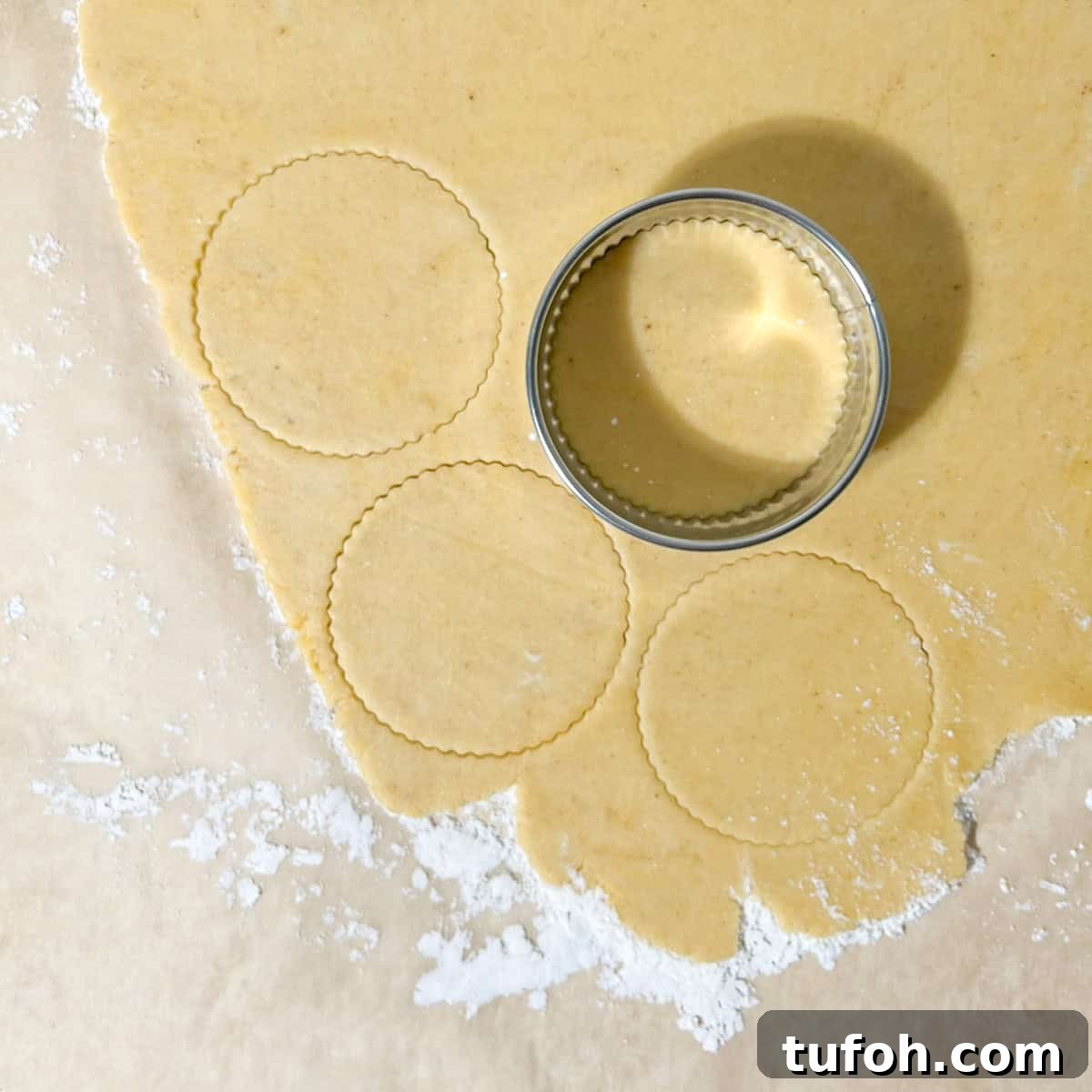 Hertzoggies: South African Jam and Coconut Tartlets Recipe 8 Cutting the pastry for the hertzoggies into circles.