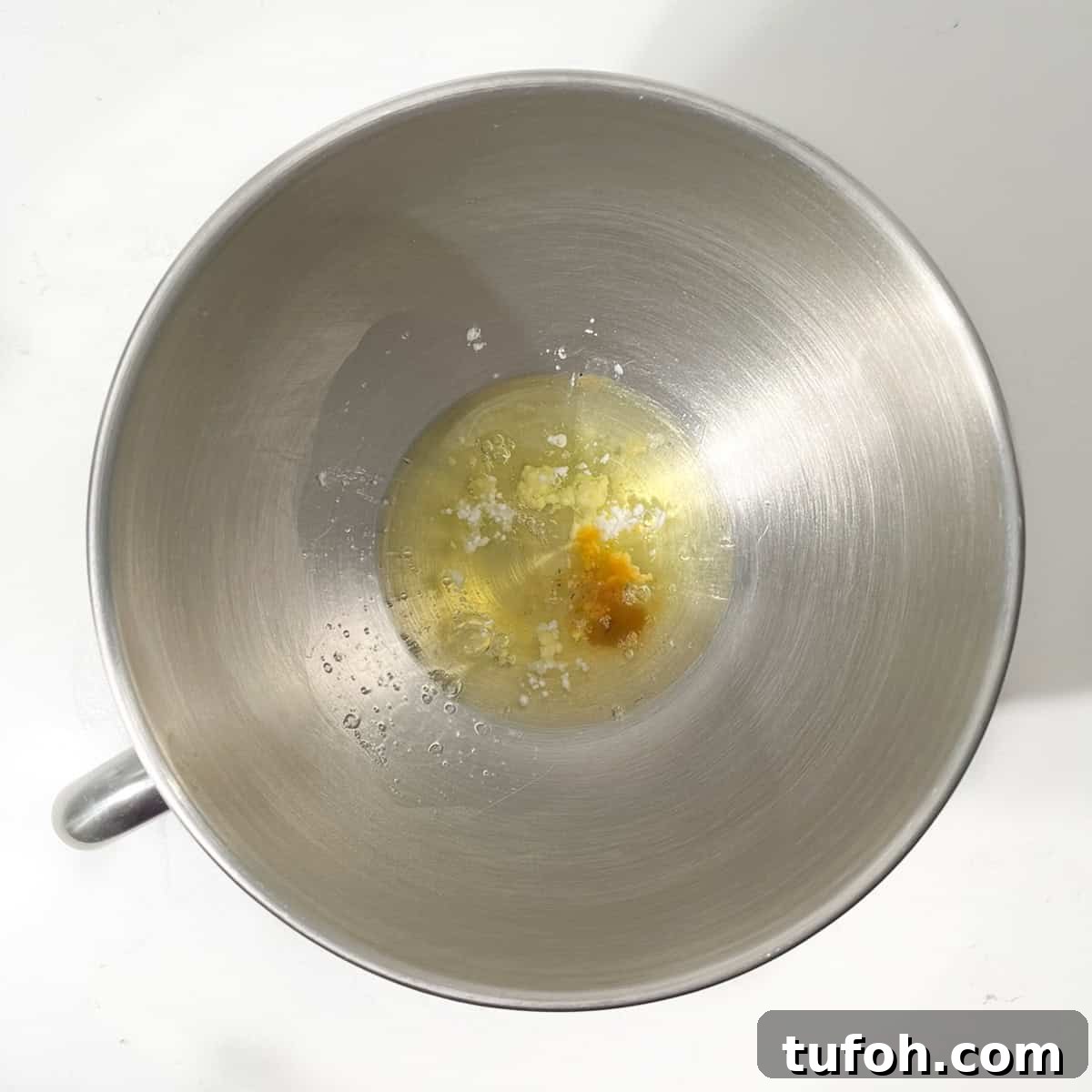 Hertzoggies: South African Jam and Coconut Tartlets Recipe 11 Adding egg white to the bowl of a stand mixer.