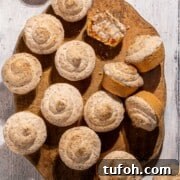 Hertzoggies on a wooden board on a white background.