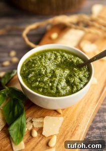 pesto in a small white pot on wooden chopping board