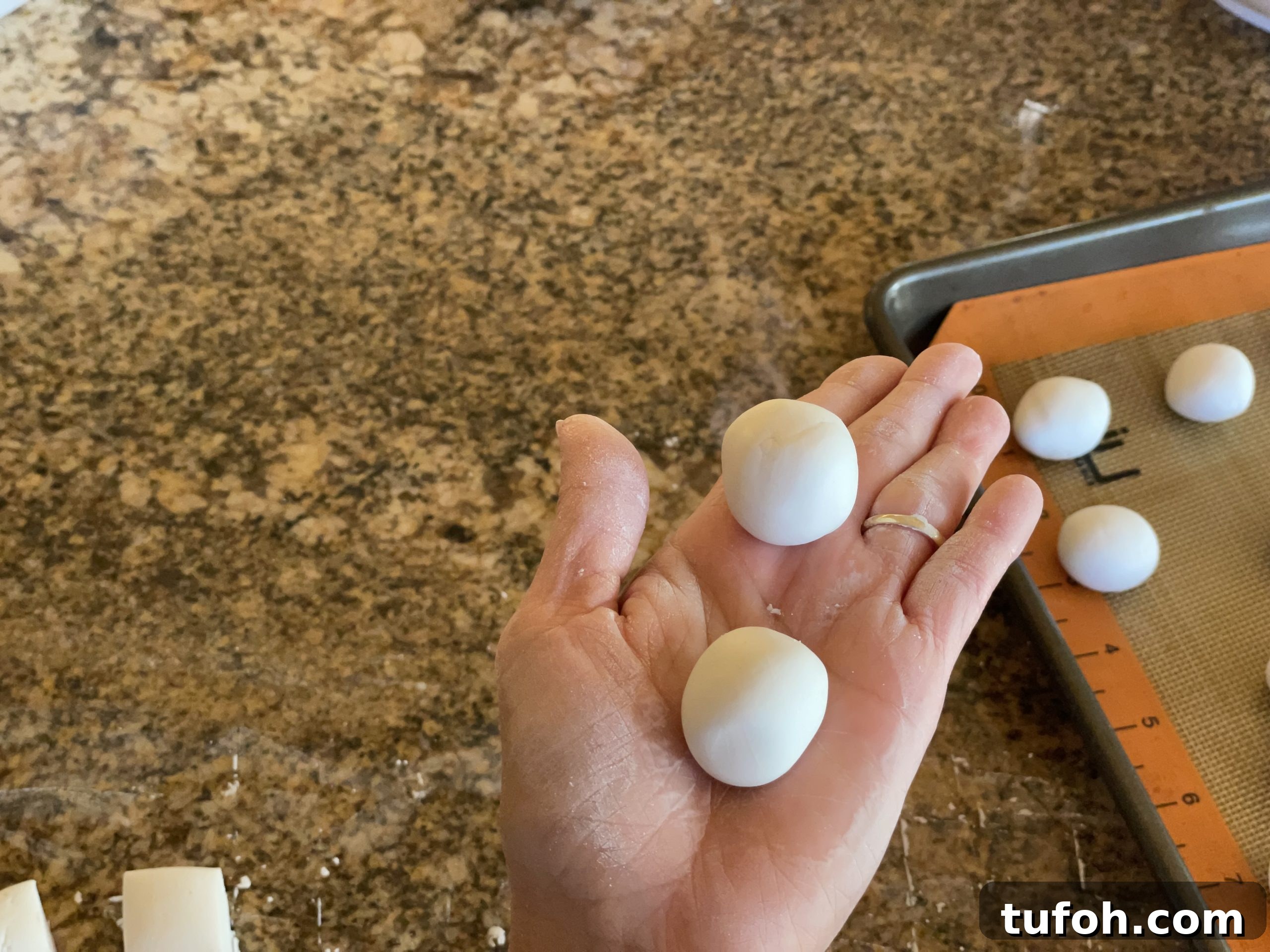 Roll pieces of dough into balls.