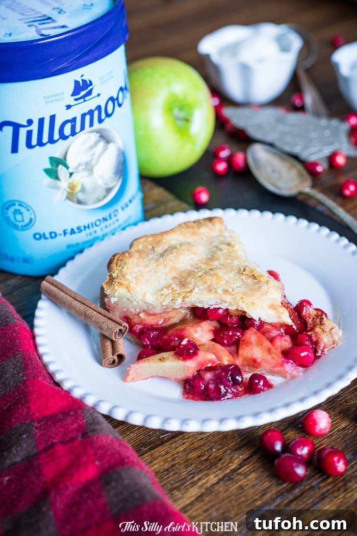 Apple Cranberry Pie, a homemade double pie crust pie stuffed with cinnamon-spiced apples and cranberries.