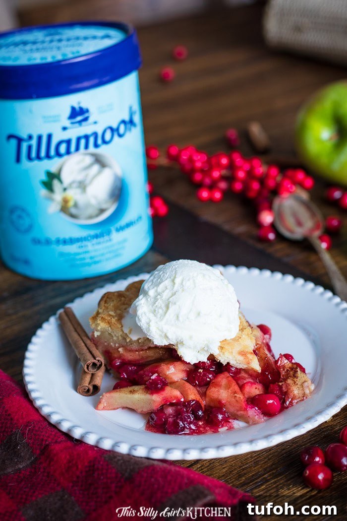 Apple Cranberry Pie, a homemade double pie crust pie stuffed with cinnamon-spiced apples and cranberries.