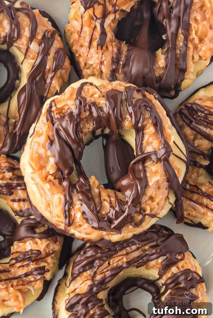 Homemade Samoa Cookies are a copycat version of everyone's favorite Girl Scout Cookie! These big, thick, and buttery shortbread cookies melt in your mouth and are packed with chocolate, caramel, and coconut. 