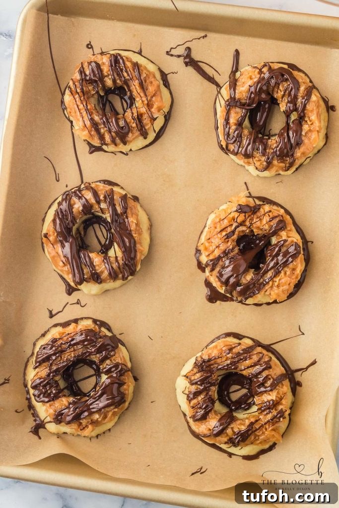 Homemade Samoa Cookies are a copycat version of everyone's favorite Girl Scout Cookie! These big, thick, and buttery shortbread cookies melt in your mouth and are packed with chocolate, caramel, and coconut.