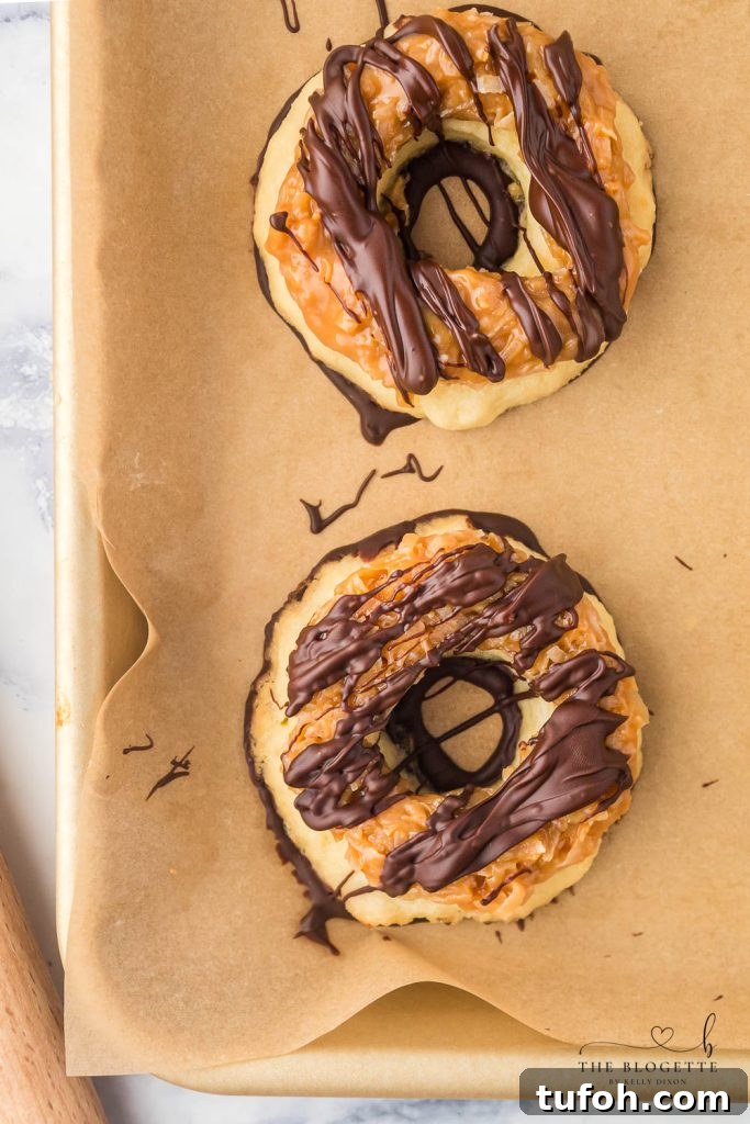 Homemade Samoa Cookies are a copycat version of everyone's favorite Girl Scout Cookie! These big, thick, and buttery shortbread cookies melt in your mouth and are packed with chocolate, caramel, and coconut.